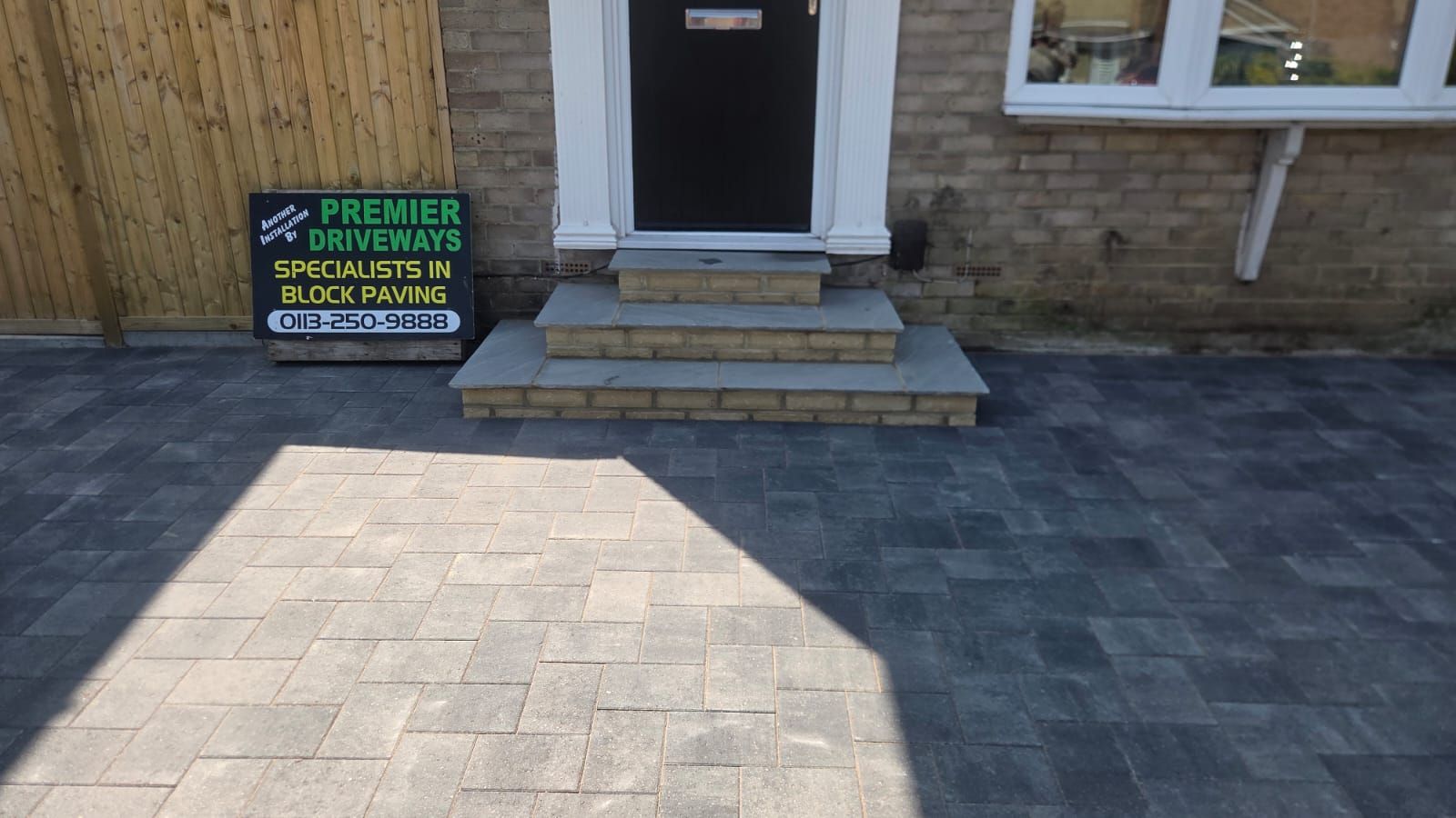 Grey block paving driveway in Farsley with integrated entrance steps and additional off-road parking