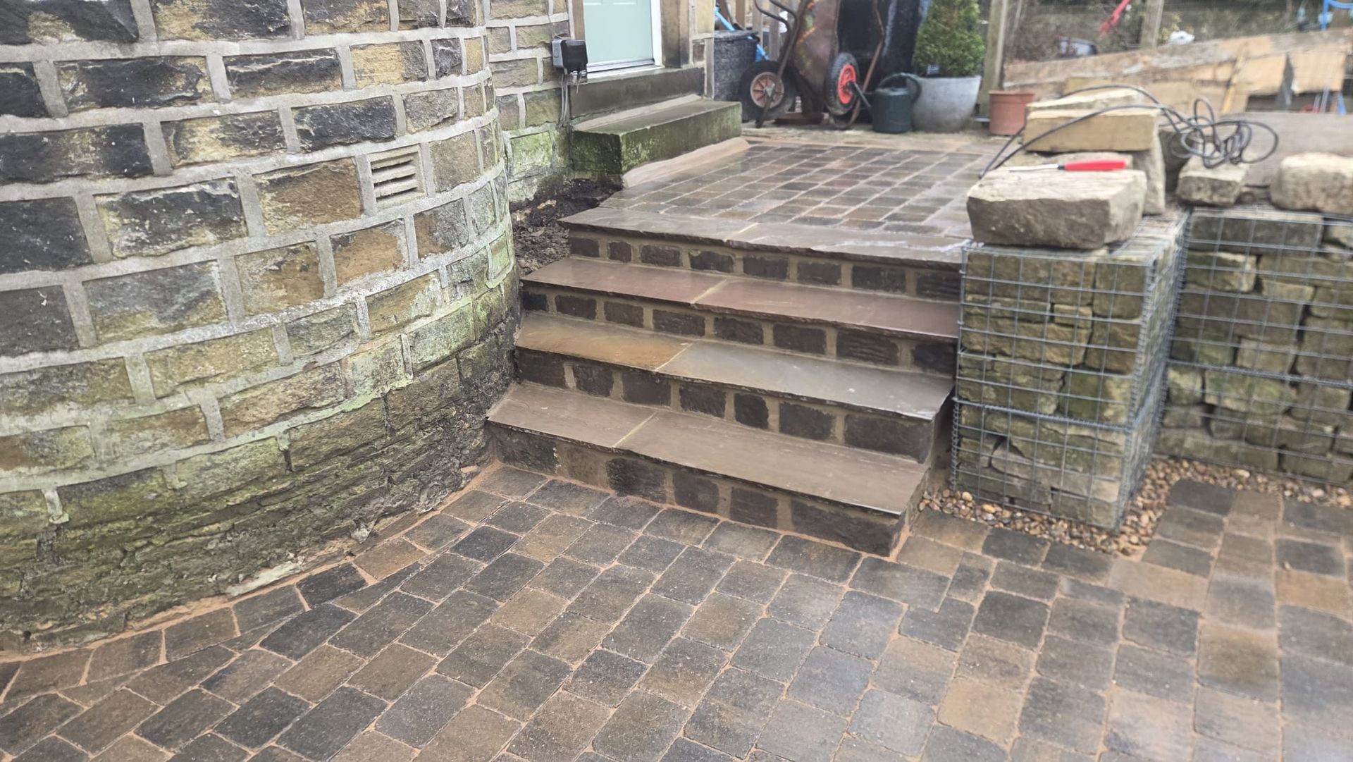 Plaspave Sorrento Sarsen Stone paving with reused stone walls and steps in Howarth