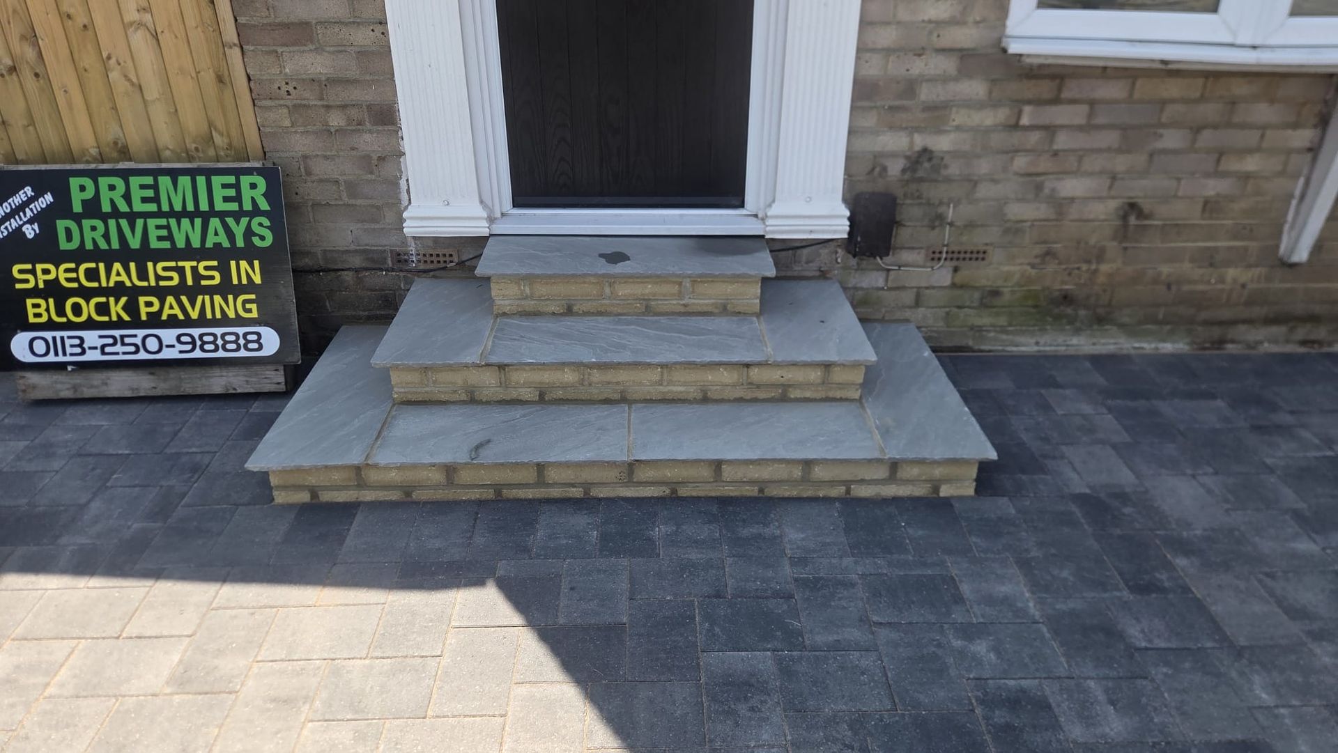 Grey block paving driveway in Farsley with integrated entrance steps and additional off-road parking