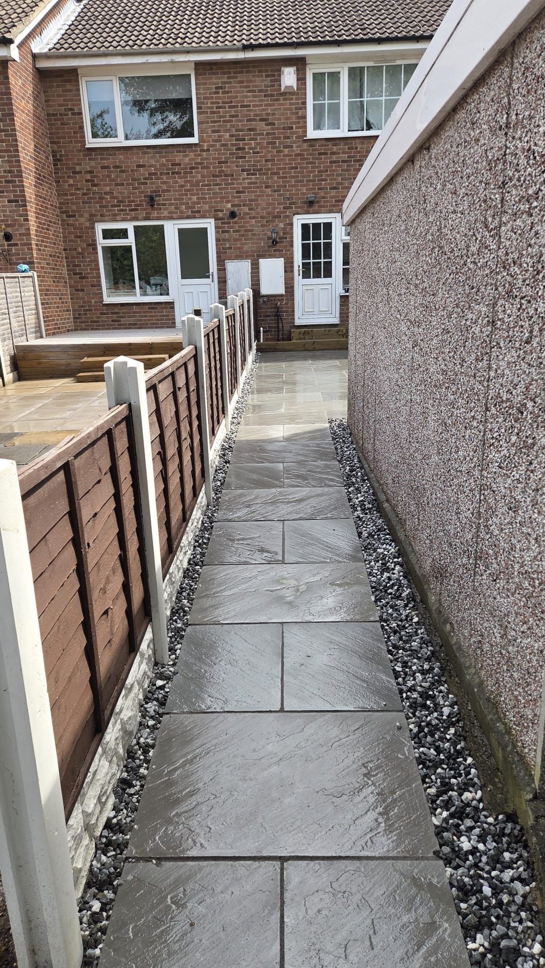 Kandla Grey Indian stone with fencing, sleeper planters and steps in Farsley