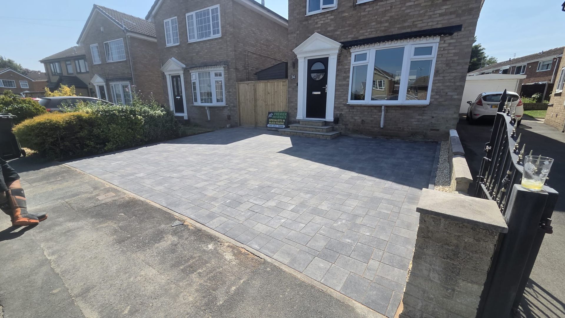 Grey block paving driveway in Farsley with integrated entrance steps and additional off-road parking