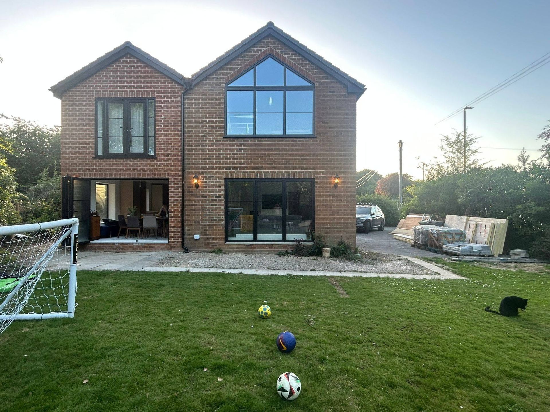 Raised grey patio beside a brick home in Horsforth